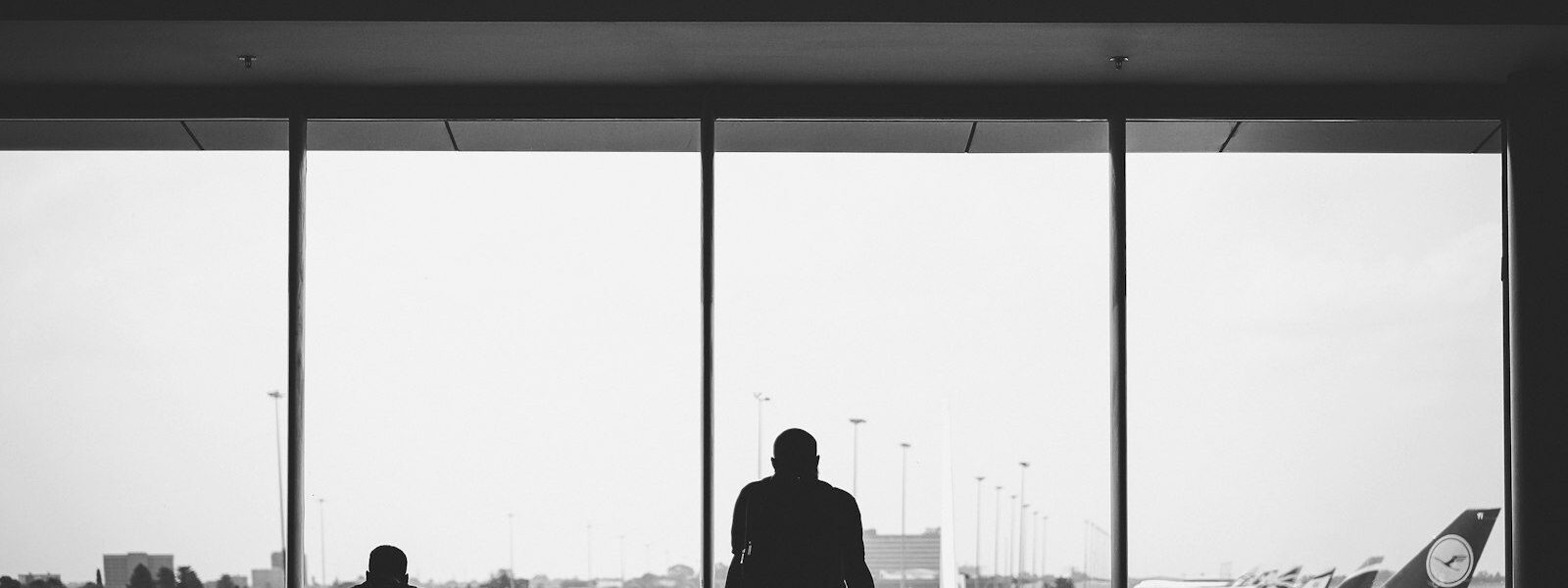 Travellers waiting to board at an airport gate window